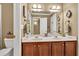 Bathroom features a double sink vanity with dark wood cabinets and decorative accents at 3125 Flatbottom Dr, Dacula, GA 30019