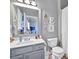 Stylish bathroom with a gray vanity, modern fixtures, a framed mirror, and a fresh, clean aesthetic at 3125 Flatbottom Dr, Dacula, GA 30019