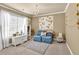 Bedroom with a large window, chandelier lighting, seating and flower themed decor at 3125 Flatbottom Dr, Dacula, GA 30019