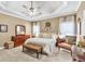Spacious bedroom featuring a tray ceiling, ceiling fan, carpeted floor and stylish decor at 3125 Flatbottom Dr, Dacula, GA 30019