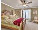 Well-lit bedroom with a four-poster bed, a ceiling fan and comfortable chair at 3125 Flatbottom Dr, Dacula, GA 30019