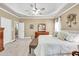 Spacious bedroom featuring a tray ceiling, carpeted floor and staircase access at 3125 Flatbottom Dr, Dacula, GA 30019