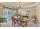 Elegant dining room with large windows, decorative chandelier, and stylish furniture at 3125 Flatbottom Dr, Dacula, GA 30019