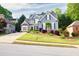 View of the house showing its landscaped front yard, long driveway, and complementary greenery surrounding the property at 3125 Flatbottom Dr, Dacula, GA 30019