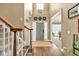 Inviting two-story foyer featuring hardwood floors, a staircase with white spindles, and a front door flanked by sidelights at 3125 Flatbottom Dr, Dacula, GA 30019