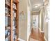 Hallway features hardwood floors, decor accents, and doors leading to different areas of the home at 3125 Flatbottom Dr, Dacula, GA 30019