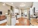 Modern kitchen open to the living area and dining, complete with wood floors and breakfast bar at 3125 Flatbottom Dr, Dacula, GA 30019