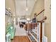 Bright living room featuring a fireplace, hardwood floors, and a staircase leading upstairs with a beige accent wall at 3125 Flatbottom Dr, Dacula, GA 30019