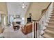 Comfortable living room featuring a fireplace, TV, staircase and comfy furniture at 3125 Flatbottom Dr, Dacula, GA 30019