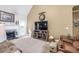 Bright living room features a fireplace, TV, and comfy furniture, designed for cozy living and relaxing at 3125 Flatbottom Dr, Dacula, GA 30019