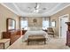 Elegant main bedroom featuring tray ceilings, neutral decor, and carpeted floors for a comfortable retreat at 3125 Flatbottom Dr, Dacula, GA 30019