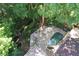 This aerial view showcases an in-ground pool, fireplace, and lush greenery at 4627 Angelo Ne Dr, Atlanta, GA 30319