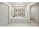 A luxurious bathroom with a soaking tub, marble floors, and a walk-in shower at 4627 Angelo Ne Dr, Atlanta, GA 30319