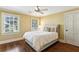 Cozy bedroom with hardwood floors, large windows, and a comfortable bed with decorative pillows at 4627 Angelo Ne Dr, Atlanta, GA 30319