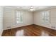 Bedroom with hardwood floors, shiplap walls and windows with blinds to allow natural light at 4627 Angelo Ne Dr, Atlanta, GA 30319