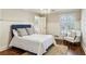 Bright bedroom featuring hardwood floors, stylish chandelier, chair, and large windows at 4627 Angelo Ne Dr, Atlanta, GA 30319