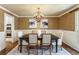 Elegant dining room with wainscoting and designer chandelier at 4627 Angelo Ne Dr, Atlanta, GA 30319