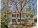 Charming two-story home with painted brick, shutters, and mature trees at 4627 Angelo Ne Dr, Atlanta, GA 30319