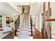 Grand foyer with staircase, hardwood floors, and elegant lighting at 4627 Angelo Ne Dr, Atlanta, GA 30319