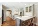 Open kitchen with white cabinets, stainless appliances, tile backsplash, and a central island with barstool seating at 4627 Angelo Ne Dr, Atlanta, GA 30319