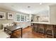 Open kitchen with island and bar seating, white cabinets, tile backsplash, stainless appliances and window over sink at 4627 Angelo Ne Dr, Atlanta, GA 30319