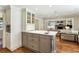 Bright kitchen with stainless steel appliances, central island, and quartz countertops open to the living room at 4627 Angelo Ne Dr, Atlanta, GA 30319