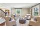 Cozy living room with a gray tufted ottoman and matching chairs at 4627 Angelo Ne Dr, Atlanta, GA 30319