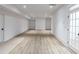 Basement features light hardwood floors, white walls and trim, and white doors that lead to other rooms at 464 Pine Tree Ne Dr, Atlanta, GA 30305