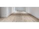 Basement features light hardwood floors, white walls and trim, and white doors that lead to other rooms at 464 Pine Tree Ne Dr, Atlanta, GA 30305