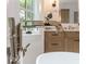 Close up of a sleek chrome faucet and pristine white bathtub with stylish cabinetry in the background at 464 Pine Tree Ne Dr, Atlanta, GA 30305