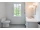 Bright bathroom with white cabinet, granite countertop, and window at 464 Pine Tree Ne Dr, Atlanta, GA 30305