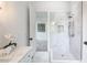 A sleek walk-in shower featuring marble tile, a handheld sprayer, and a built-in niche at 464 Pine Tree Ne Dr, Atlanta, GA 30305