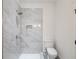 Bathroom featuring tile shower with shower niche and modern fixtures at 464 Pine Tree Ne Dr, Atlanta, GA 30305