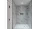 Contemporary bathroom showcasing a glass enclosed shower with gray tiled walls and bright lighting at 464 Pine Tree Ne Dr, Atlanta, GA 30305