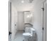 Bathroom with a gray tiled floor, white walls, and a white vanity with black hardware and a modern toilet at 464 Pine Tree Ne Dr, Atlanta, GA 30305
