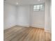 A naturally lit bedroom with wood flooring, white walls and trim provides a simple, yet comforting space at 464 Pine Tree Ne Dr, Atlanta, GA 30305