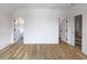 Bright bedroom featuring light hardwood floors, white walls and doors that lead to other rooms of the house at 464 Pine Tree Ne Dr, Atlanta, GA 30305