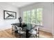 Bright dining room with large windows showcasing a view of the surrounding greenery at 464 Pine Tree Ne Dr, Atlanta, GA 30305