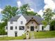 Stunning two-story home with a stone and white painted brick exterior and landscaped lawn at 464 Pine Tree Ne Dr, Atlanta, GA 30305
