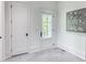 Hallway with light gray floors, white walls with white trim, and white doors with black hardware at 464 Pine Tree Ne Dr, Atlanta, GA 30305