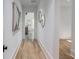 Hallway with hardwood floors, neutral walls, and artwork at 464 Pine Tree Ne Dr, Atlanta, GA 30305