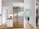 Gourmet kitchen features stainless steel refrigerator, custom cabinets, and modern design at 464 Pine Tree Ne Dr, Atlanta, GA 30305