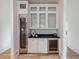 Modern kitchen features wine fridge and bar area with custom cabinets at 464 Pine Tree Ne Dr, Atlanta, GA 30305