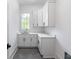 Bright laundry room features white cabinets, a sink, and a large window for natural light at 464 Pine Tree Ne Dr, Atlanta, GA 30305