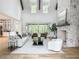 Bright, airy living room boasts high ceilings, a stone fireplace, and sliding doors to a covered patio at 464 Pine Tree Ne Dr, Atlanta, GA 30305