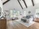 Bright primary bedroom with high ceilings, exposed beams, large windows, and hardwood floors at 464 Pine Tree Ne Dr, Atlanta, GA 30305