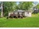 Manicured backyard featuring lush greenery, an outdoor deck and mature trees at 960 Lindridge Ne Dr, Atlanta, GA 30324