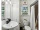 Bathroom featuring a sleek pedestal sink and a window for natural light at 960 Lindridge Ne Dr, Atlanta, GA 30324