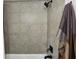 Bathroom featuring gray tiled walls, a shower, and black fixtures at 960 Lindridge Ne Dr, Atlanta, GA 30324
