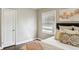 Bright bedroom featuring wood floors, large window, and warm decor at 960 Lindridge Ne Dr, Atlanta, GA 30324